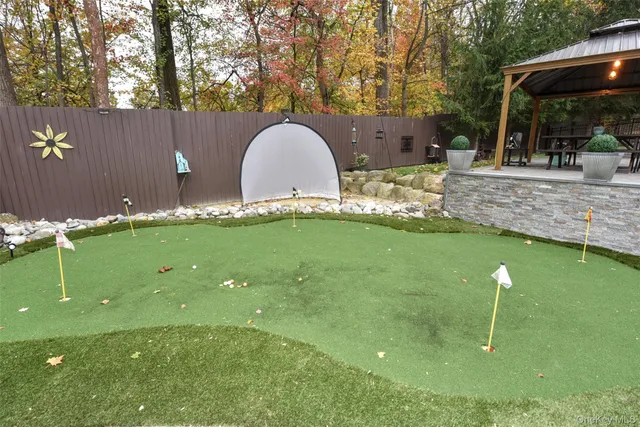 a swimming pool with outdoor seating and yard