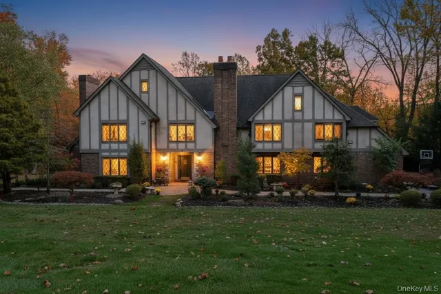 a front view of house with yard and green space