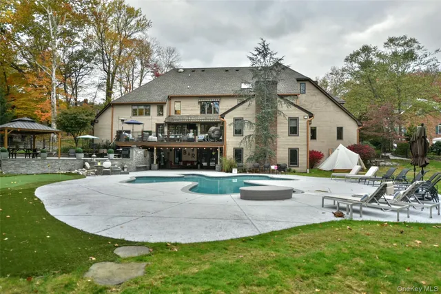 a view of a house with swimming pool and sitting area