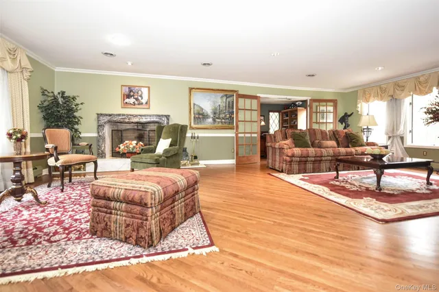 a living room with furniture large window and a table