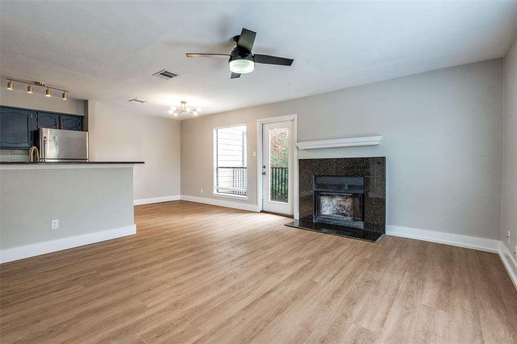 3022 Forest Lane, Unit 315 Dallas, TX 75234 - Photo 2 of 12 a view of an empty room with a fireplace and a window