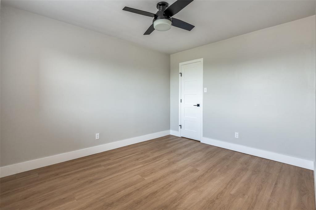 3022 Forest Lane, Unit 315 Dallas, TX 75234 - Photo 9 of 12 a view of room with wooden floor and ceiling fan