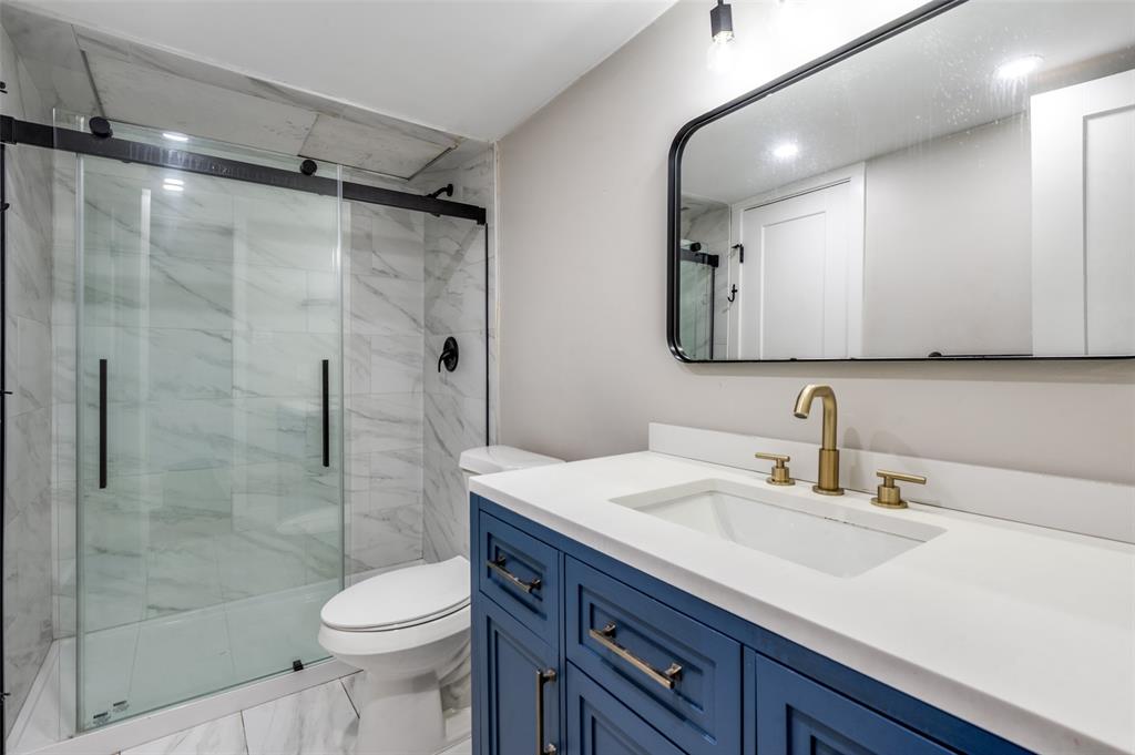 3022 Forest Lane, Unit 315 Dallas, TX 75234 - Photo 10 of 12 a bathroom with a sink vanity granite toilet and shower
