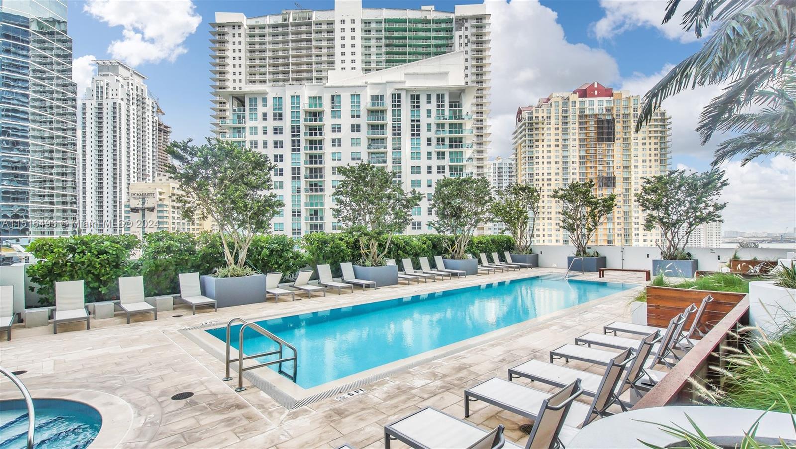 1300 Brickell Bay Drive, Unit 3003 Miami, FL 33131 - Photo 24 of 31 a view of swimming pool with outdoor seating and plants