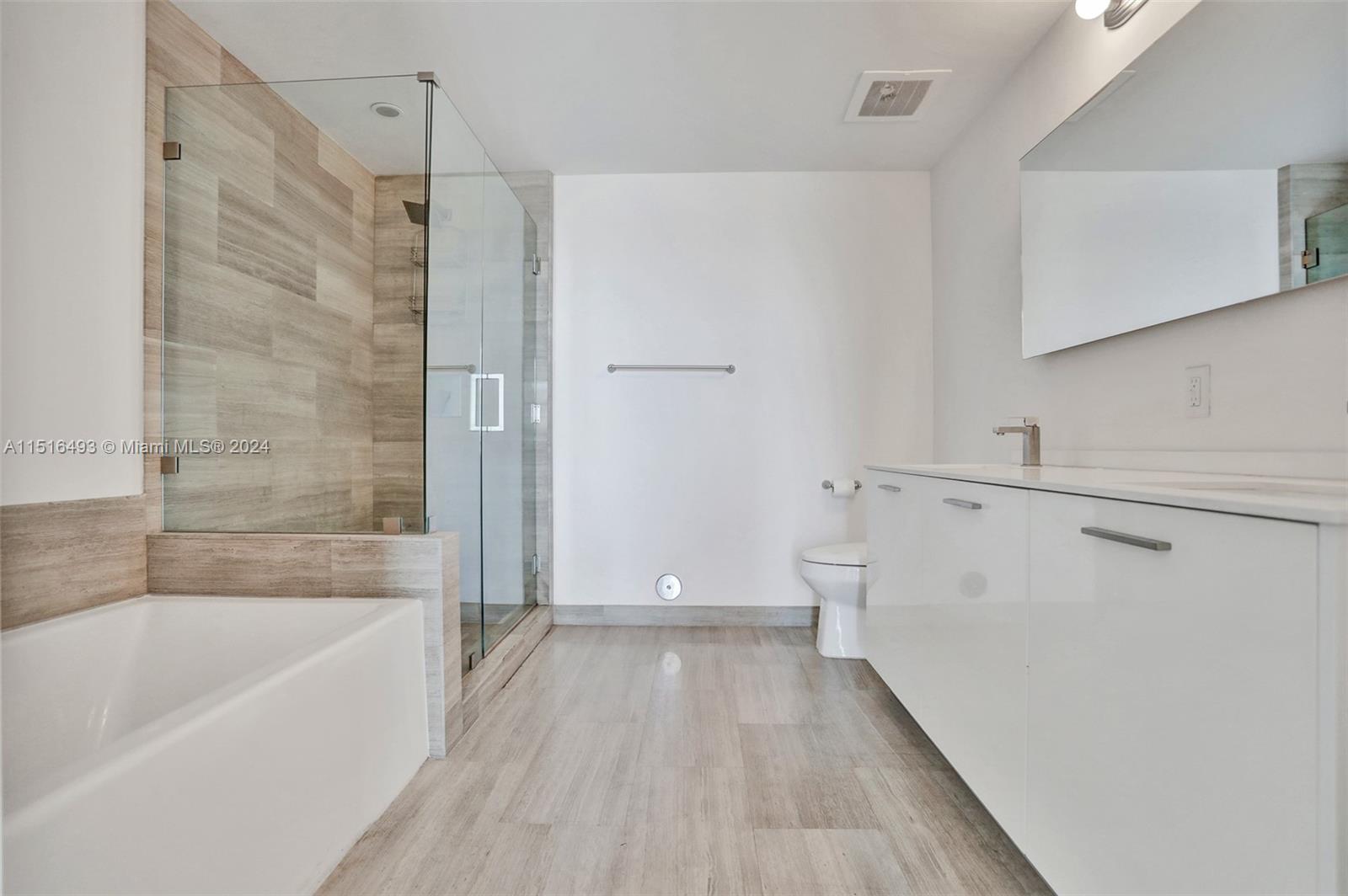 1300 Brickell Bay Drive, Unit 3003 Miami, FL 33131 - Photo 6 of 31 a bathroom with a bathtub and a shower