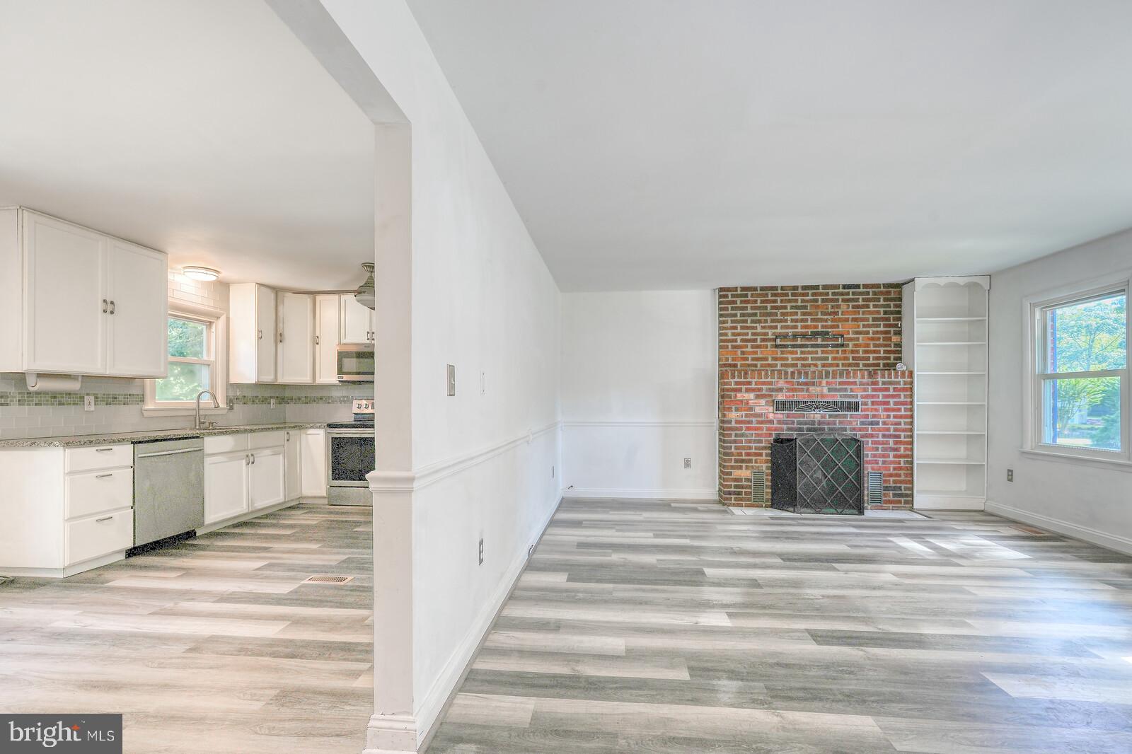 1142 Calvert Beach Road St. Leonard, MD 20685 - Photo 15 of 63 a view of a kitchen with a sink and a fireplace