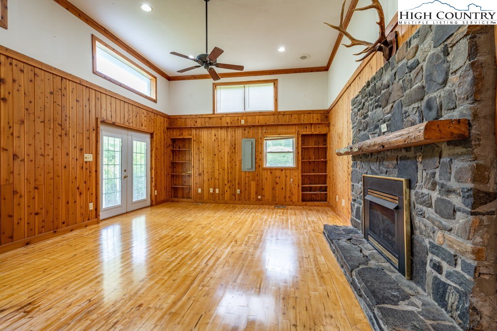 175 Roaring Fork Road Todd, NC 28684 - Photo 9 of 24 a view of empty room with wooden floor and fireplace