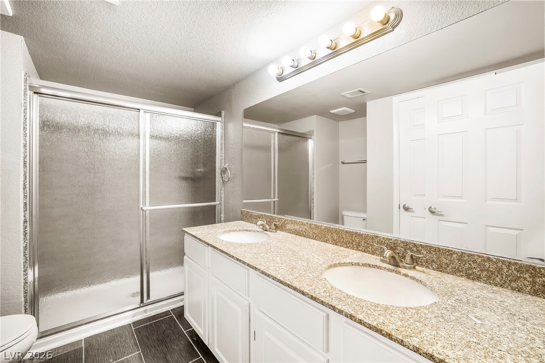 3311 Sunfish Drive, Unit D Henderson, NV 89014 - Photo 5 of 21 Double vanity with stone counters provides ample space in this refreshed bathroom.