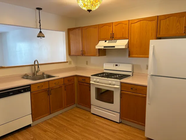a white refrigerator freezer sitting in a kitchen