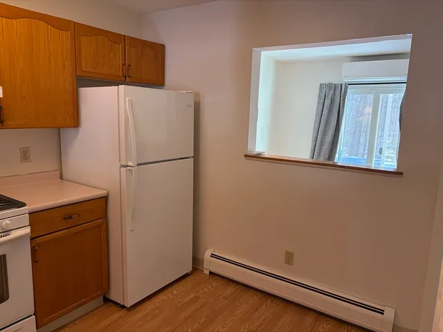 a white refrigerator freezer and a dishwasher sitting in a kitchen