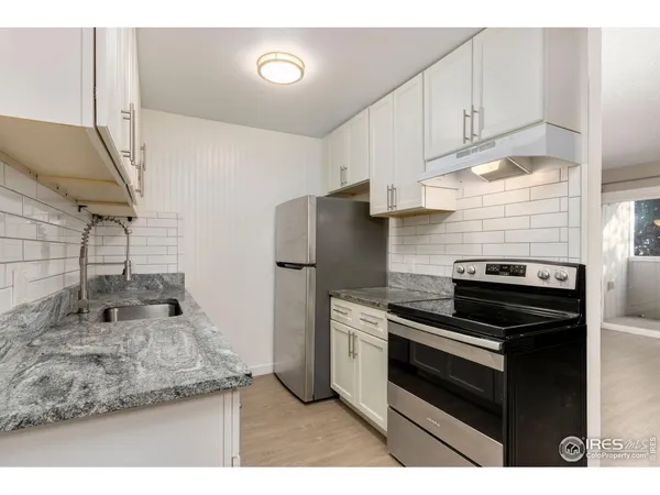 a kitchen with a stove and a refrigerator