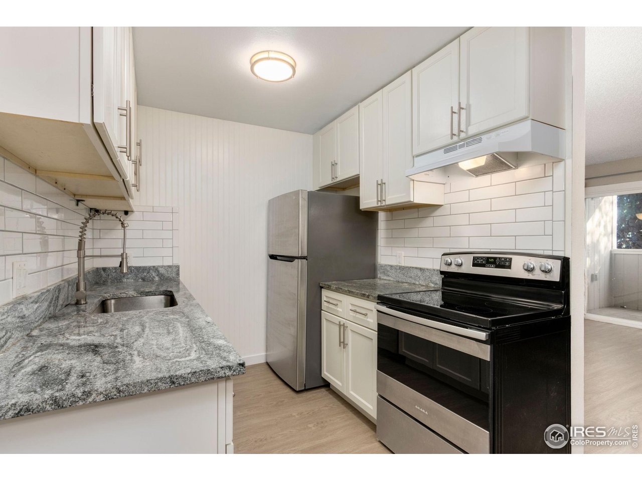 a kitchen with a stove and a refrigerator