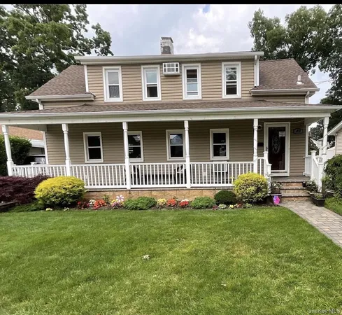 a view of a house with a small yard and plants
