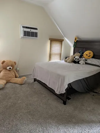 a bedroom with a bed and window