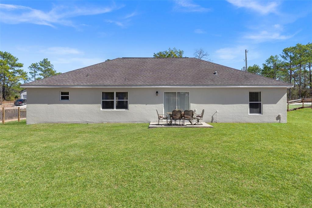 15335 Fleetwood Road Weeki Wachee, FL 34614 - Photo 38 of 40 a front view of house with yard barbeque and trees