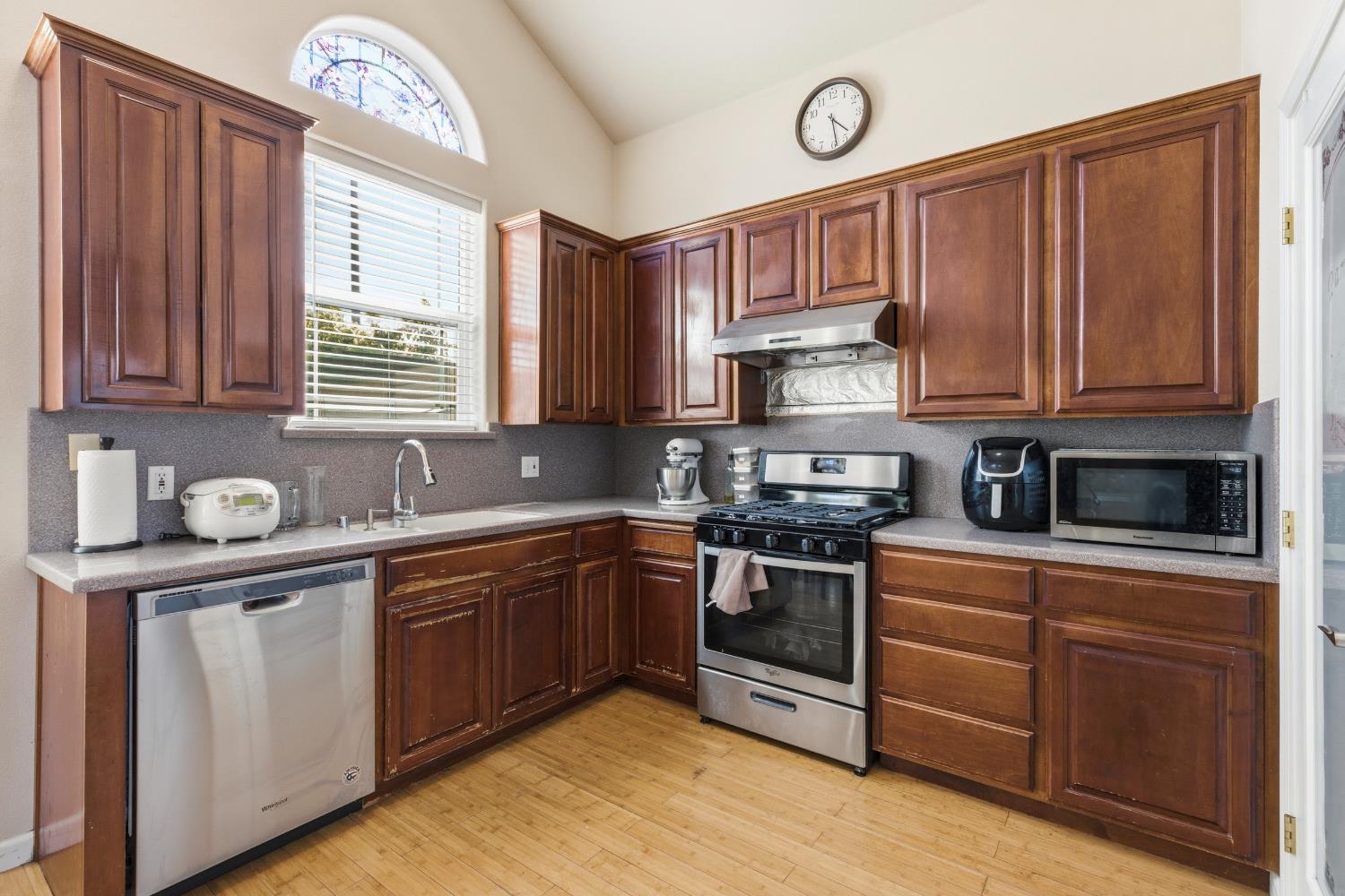 2000 Nita Alexander Court Modesto, CA 95358 - Photo 9 of 33 a kitchen with stainless steel appliances granite countertop a sink a stove a refrigerator a cabinets and wooden floor