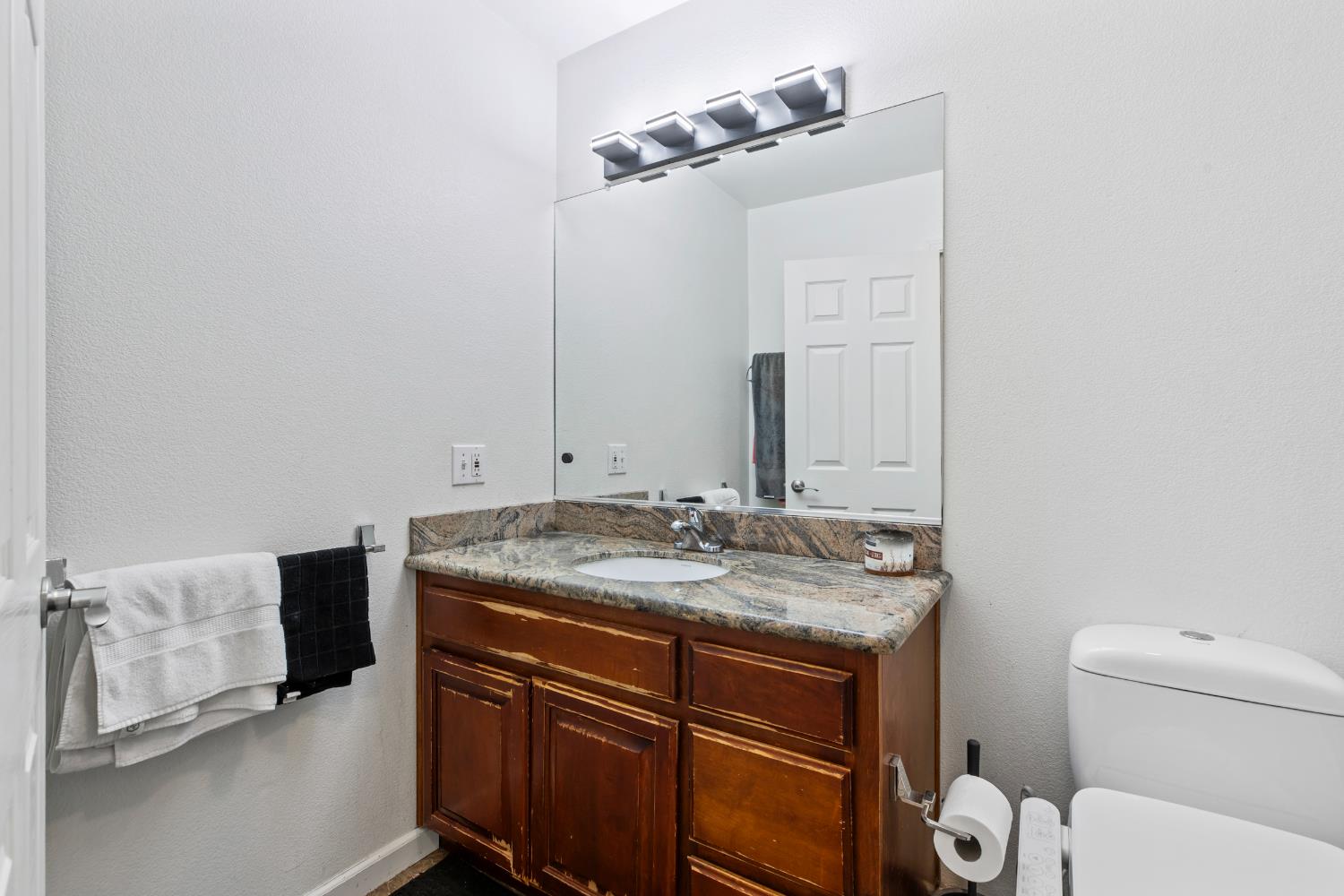 2000 Nita Alexander Court Modesto, CA 95358 - Photo 10 of 33 a bathroom with a granite countertop sink and a mirror