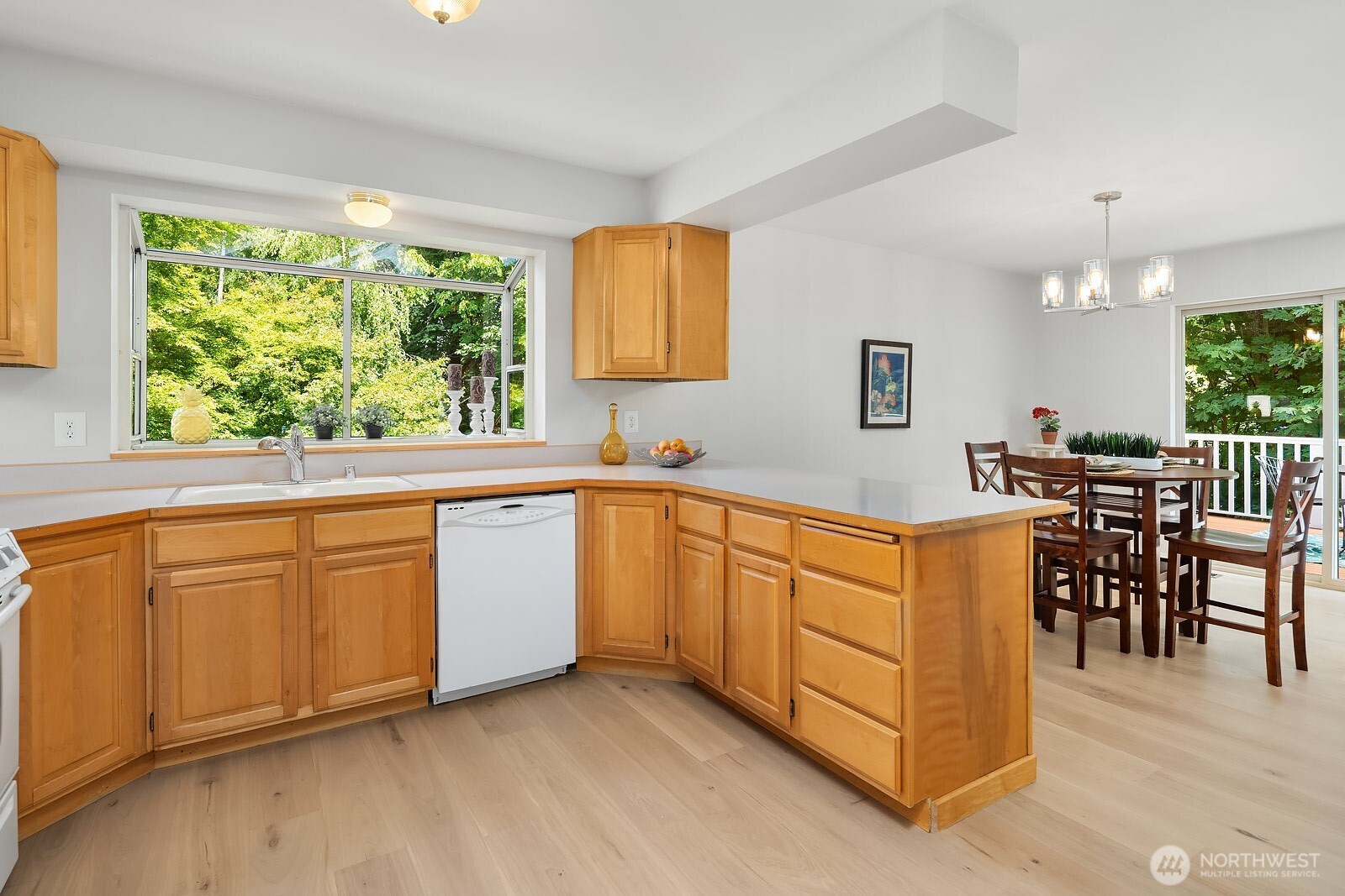 721 Crown Drive Everett, WA 98203 - Photo 14 of 40 a kitchen with stainless steel appliances granite countertop a stove a sink a dining table and chairs with wooden floor