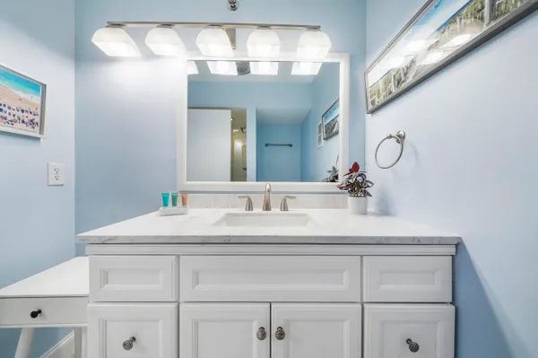 a bathroom with a sink vanity and a mirror