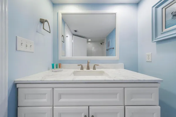 a bathroom with a sink vanity and a mirror
