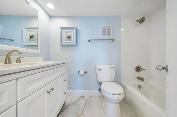 a bathroom with a sink a toilet and bathtub