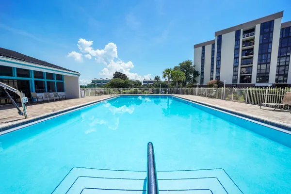 a swimming pool with outdoor seating and yard