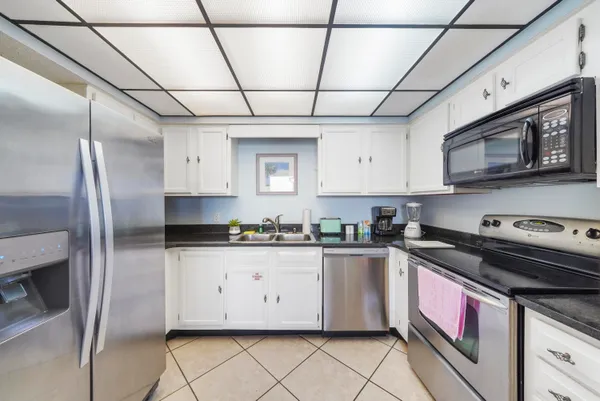 a kitchen with stainless steel appliances granite countertop a stove a sink dishwasher and a refrigerator