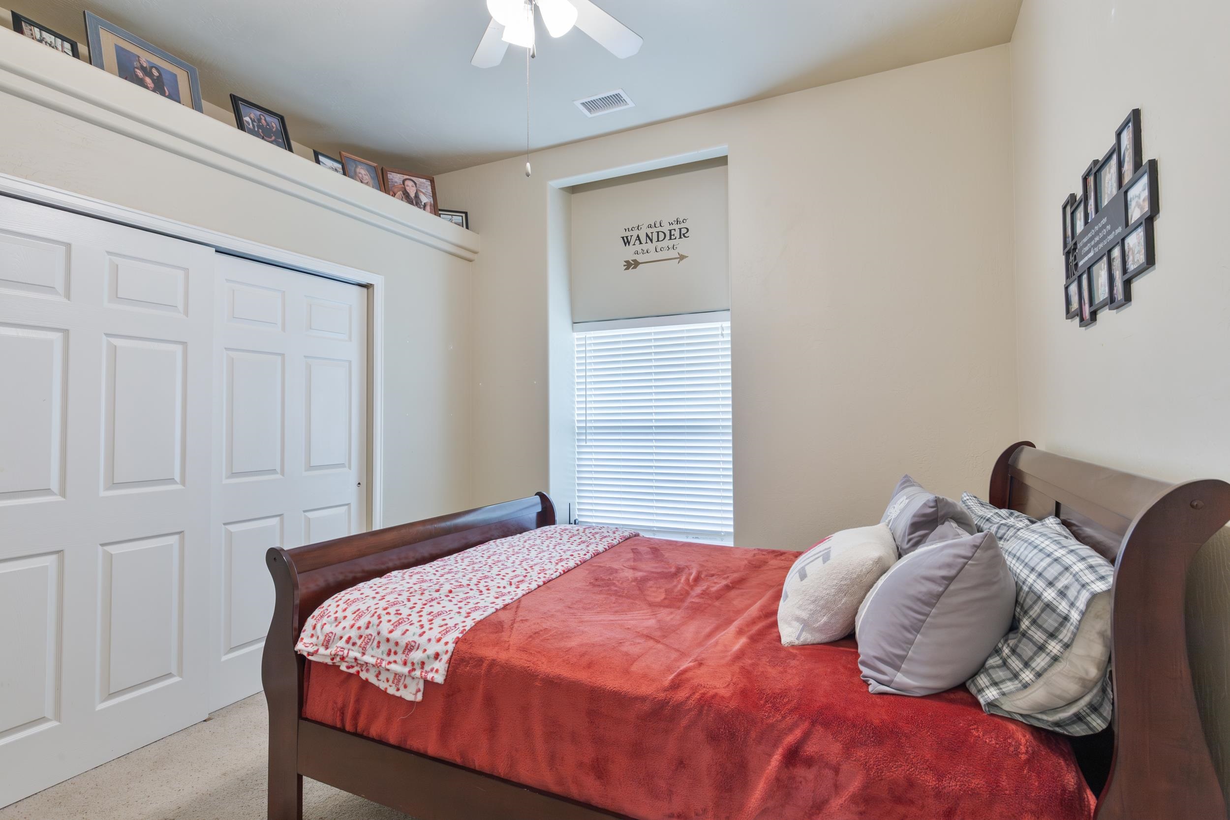 544 Hemlock Drive Fruita, CO 81521 - Photo 14 of 36 a bedroom with a bed and a chandelier