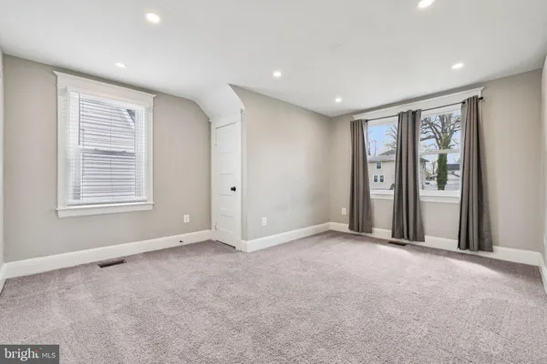 a view of an empty room with a closet