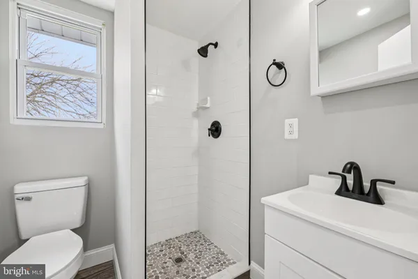 a white toilet sitting next to a bathroom sink