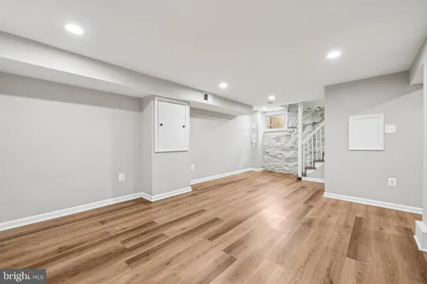 a view of empty room with wooden floor