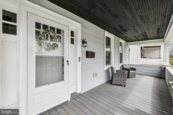 a view of dining room with wooden floor and furniture
