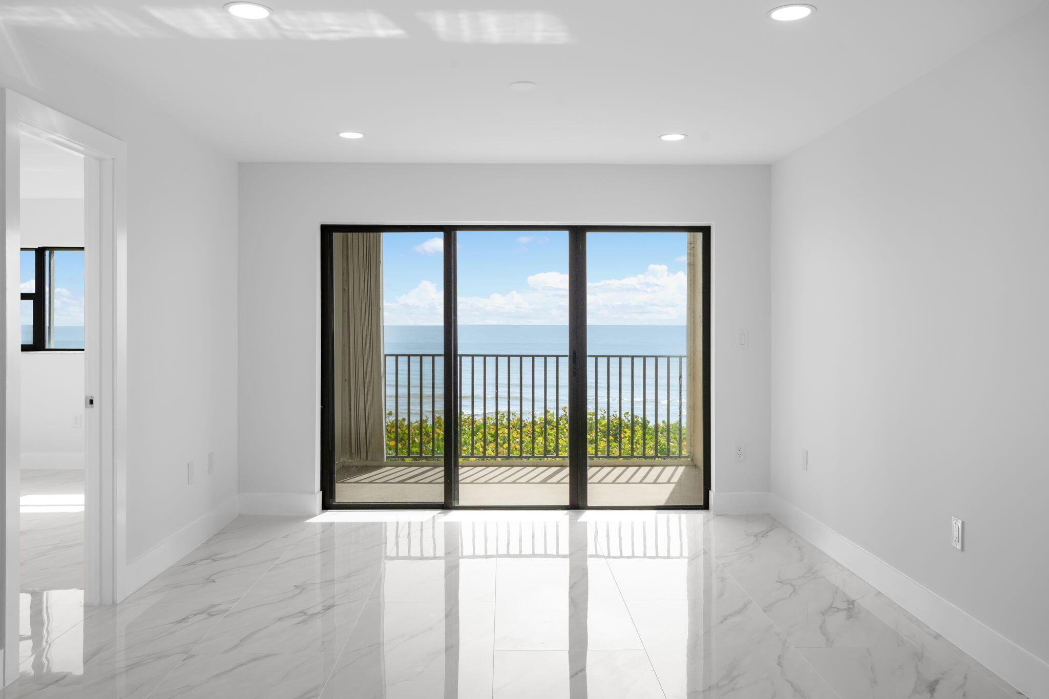 7420 South Ocean Drive, Unit 314 Jensen Beach, FL 34957 - Photo 12 of 24 a view of an empty room with wooden floor and a window