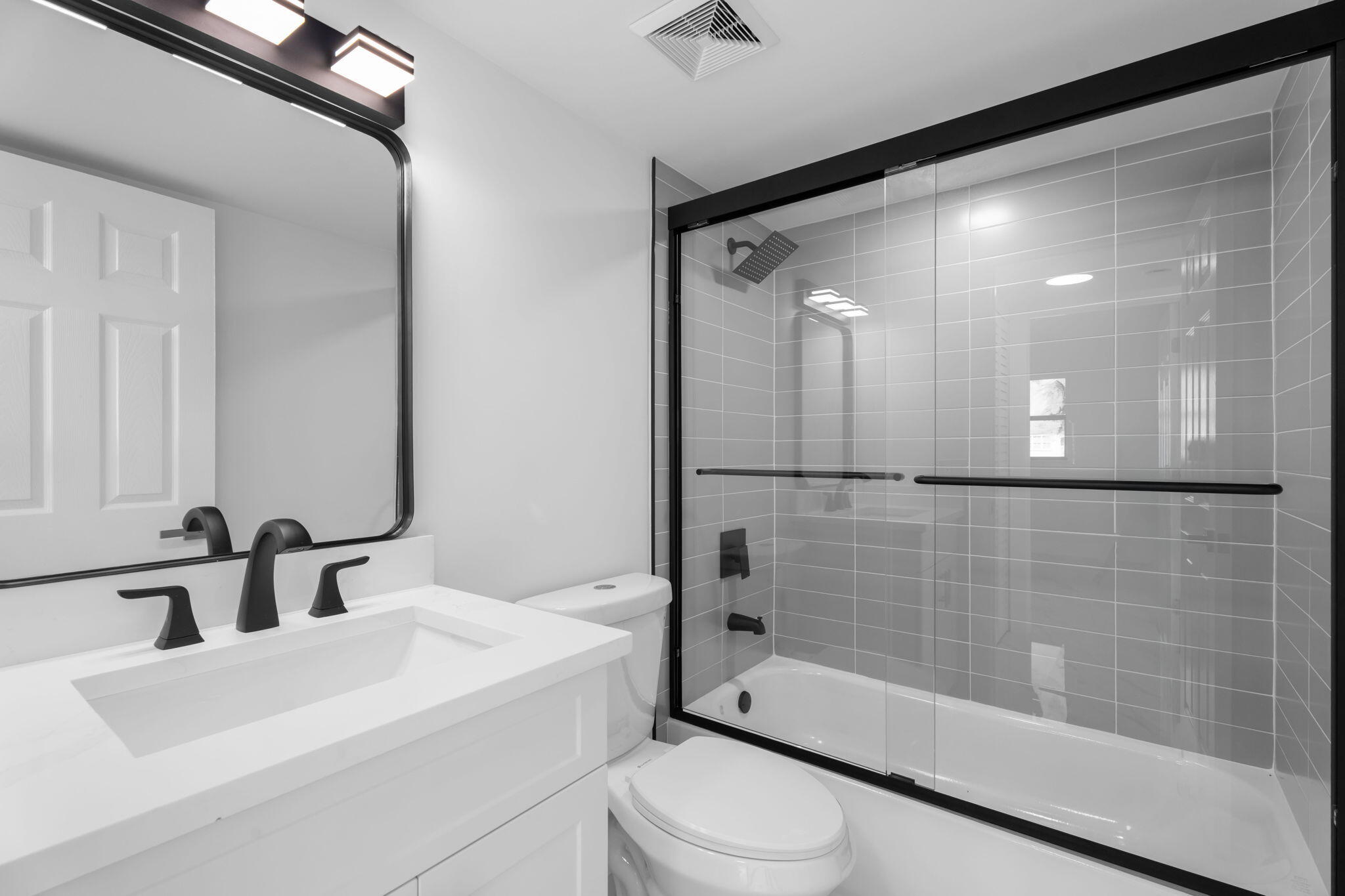 7420 South Ocean Drive, Unit 314 Jensen Beach, FL 34957 - Photo 17 of 24 a bathroom with a bathtub shower sink vanity and toilet