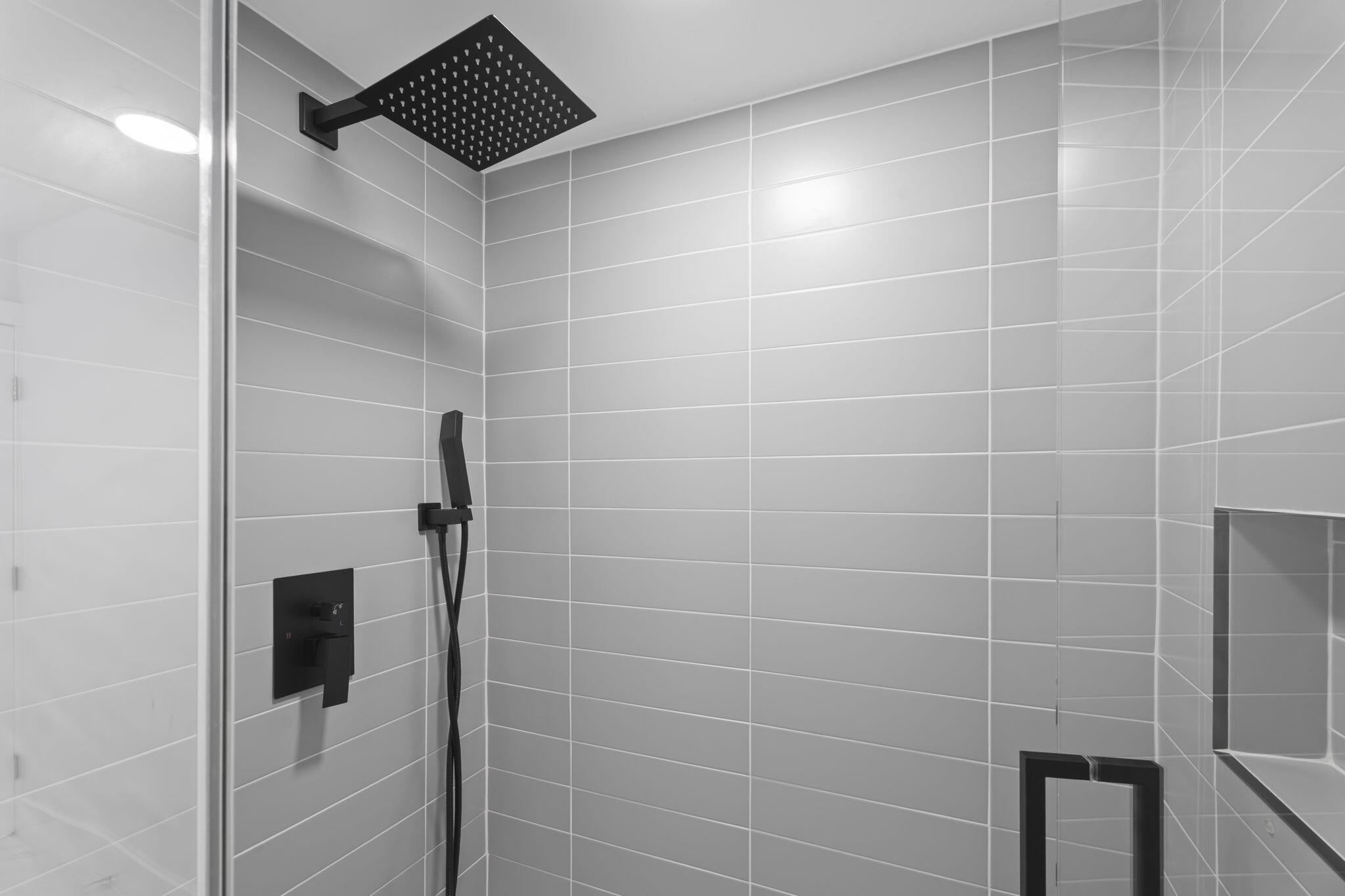 7420 South Ocean Drive, Unit 314 Jensen Beach, FL 34957 - Photo 22 of 24 a bathroom with a shower and a mirror