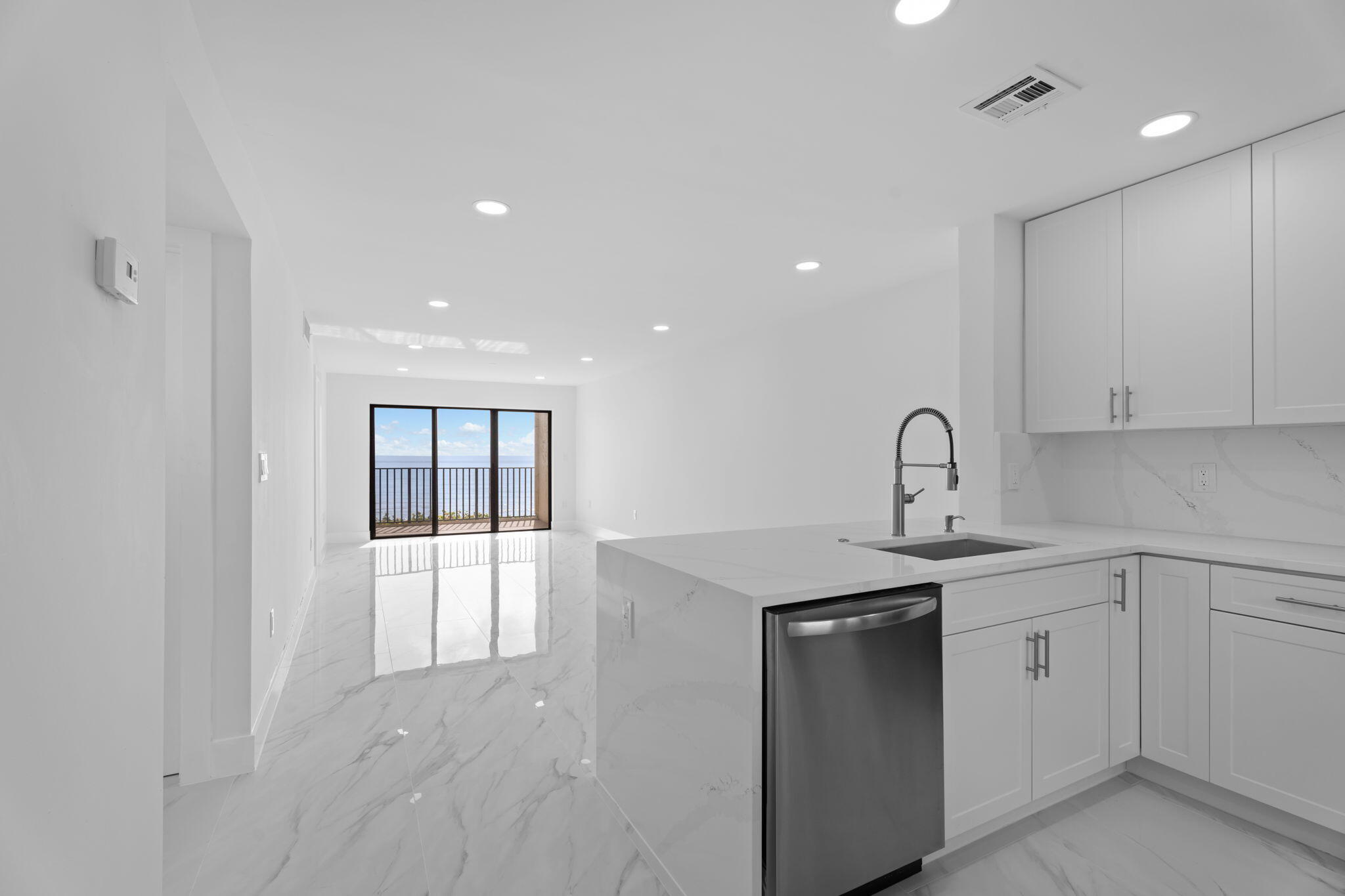 7420 South Ocean Drive, Unit 314 Jensen Beach, FL 34957 - Photo 4 of 24 a kitchen with white cabinets appliances and sink