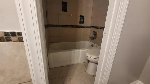a bathroom with a toilet and a shower