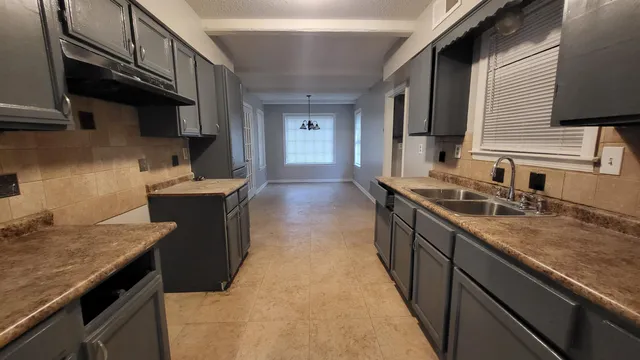 a kitchen with stainless steel appliances granite countertop a sink stove and cabinets