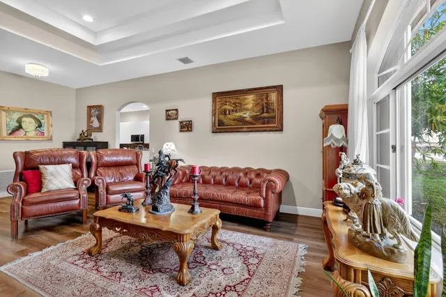 a living room with furniture and wooden floor