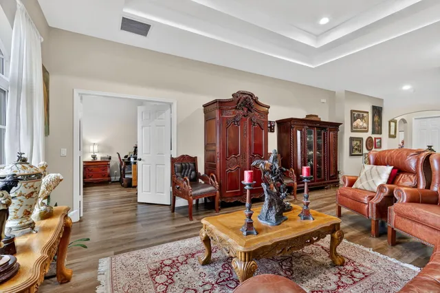 a view of a workspace with furniture and floor to ceiling window
