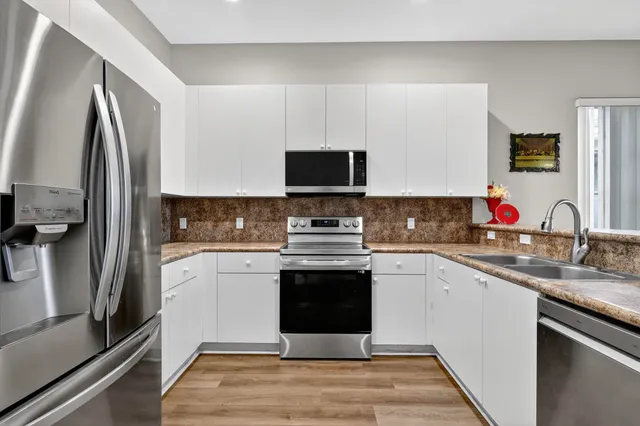 a bathroom with a granite countertop sink mirror and vanity