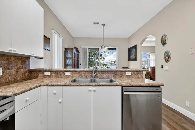 a kitchen with a sink stove and microwave