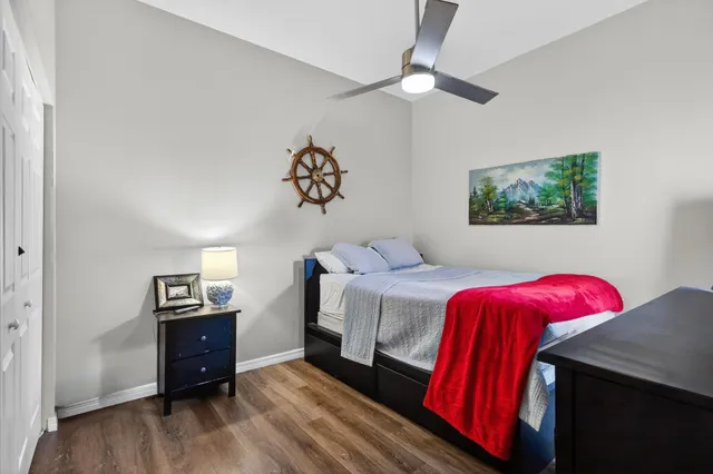 a view of a balcony with chairs and a large tree