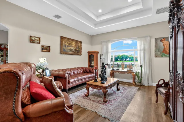 a living room with furniture a rug and a lamp