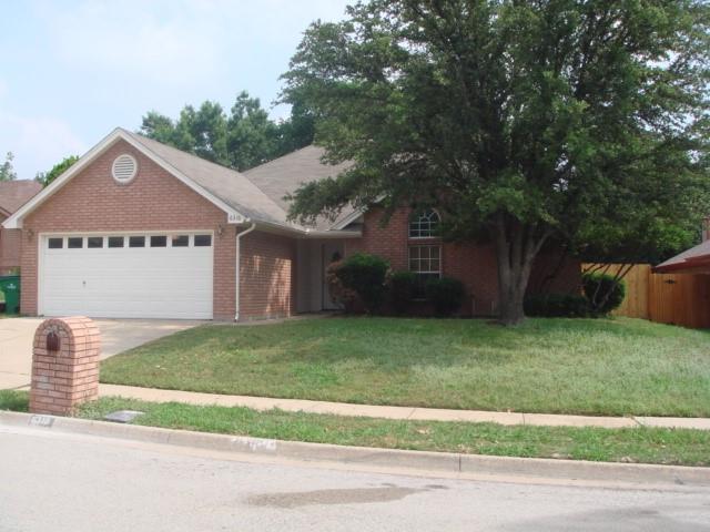 a view of a big house with a big yard and large trees