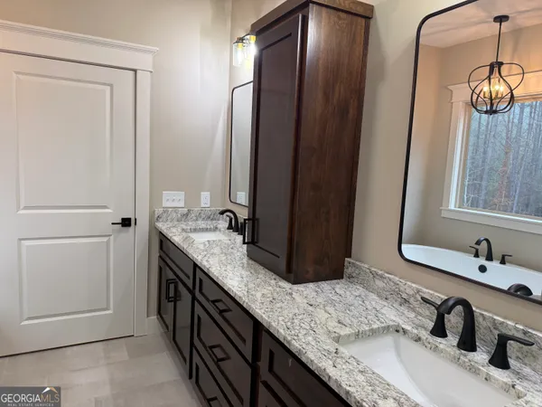 a bathroom with a double vanity sink and a mirror