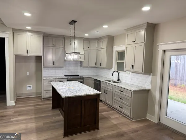 a kitchen with a sink stove and refrigerator