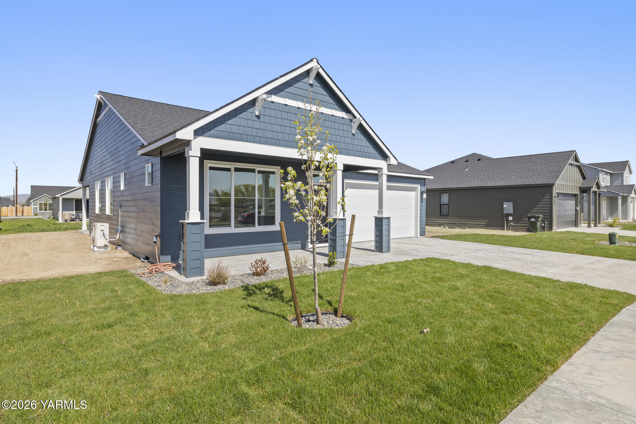 313 Amberly Avenue Grandview, WA 98930 - Photo 18 of 18 a front view of a house with a yard table and chairs