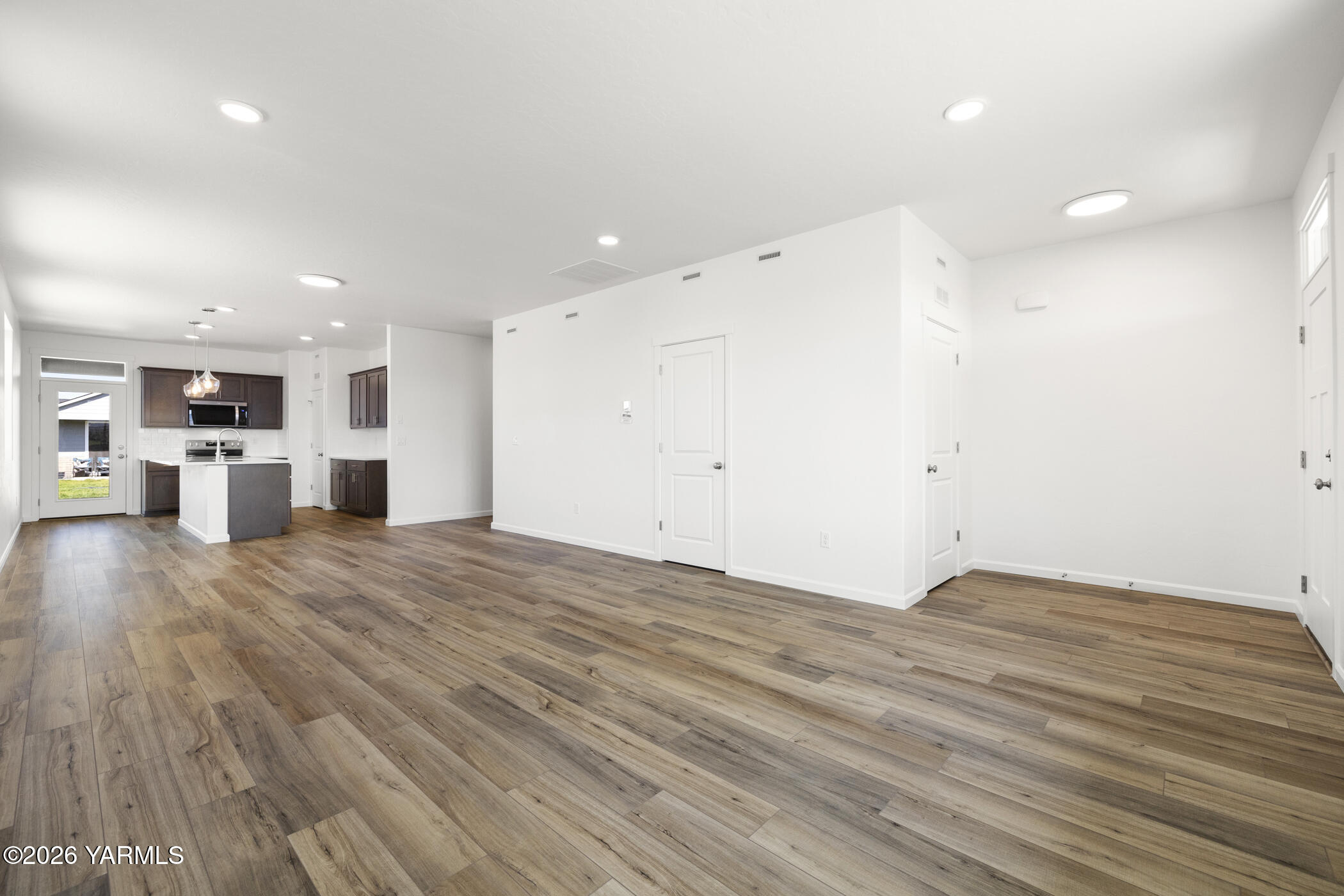 313 Amberly Avenue Grandview, WA 98930 - Photo 4 of 18 a view of empty room with wooden floor