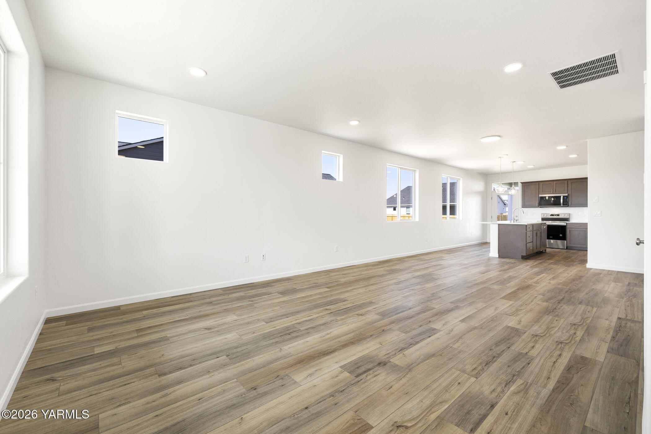 313 Amberly Avenue Grandview, WA 98930 - Photo 6 of 18 a view of empty room with wooden floor